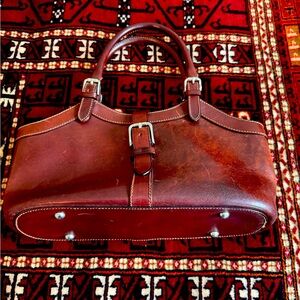 Dooney & Bourke vintage small brown leather purse with silver buckles and feet.